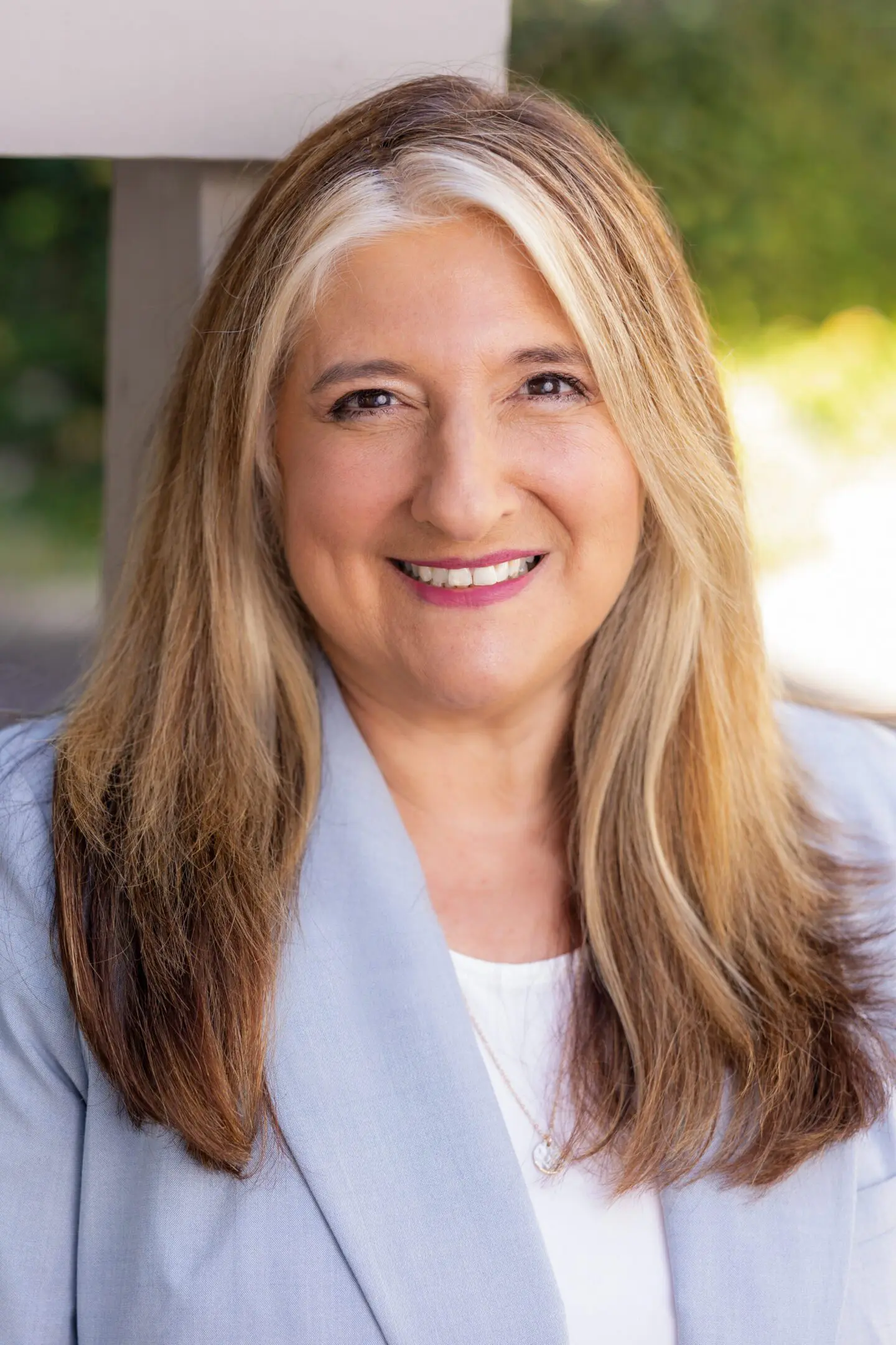 Woman in a jacket at the camera with a blurred background